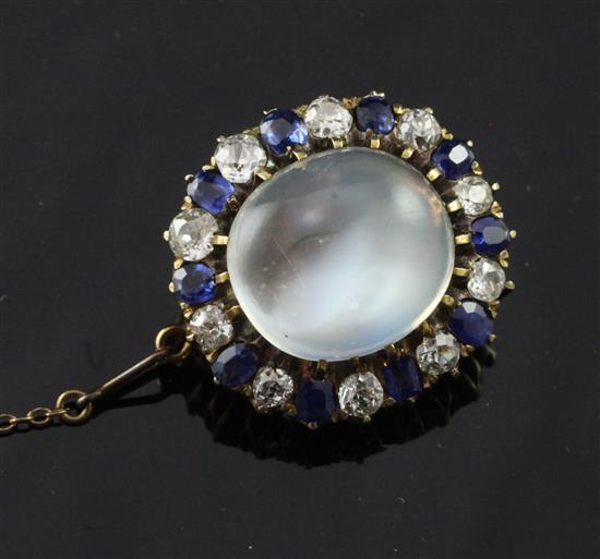 A gold, moonstone, diamond and sapphire oval brooch with safety chain, 1in.